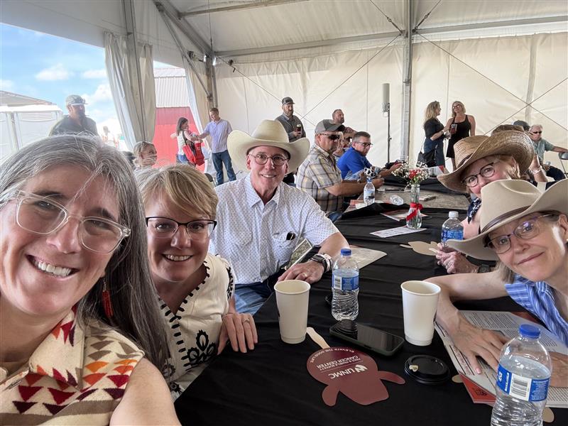 Selfie of cancer center faculty seated at a table