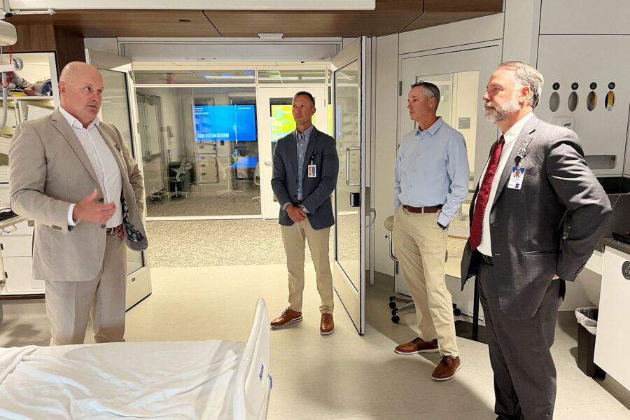 In the med center's Innovation Design Unit&comma; Chad Vokoun &lpar;at left&rpar;&comma; MD&comma; chief and professor in the UNMC Division of Hospital Medicine&comma; talks with leaders visiting from Beatrice Community Hospital & Health Center&period; The guests were&comma; from right&comma; Rick Haraldson&comma; CEO&comma; Eric Trusty&comma; senior executive for clinic services&comma; and Steve Paulmeyer&comma; MD&comma; chief medical officer&period;