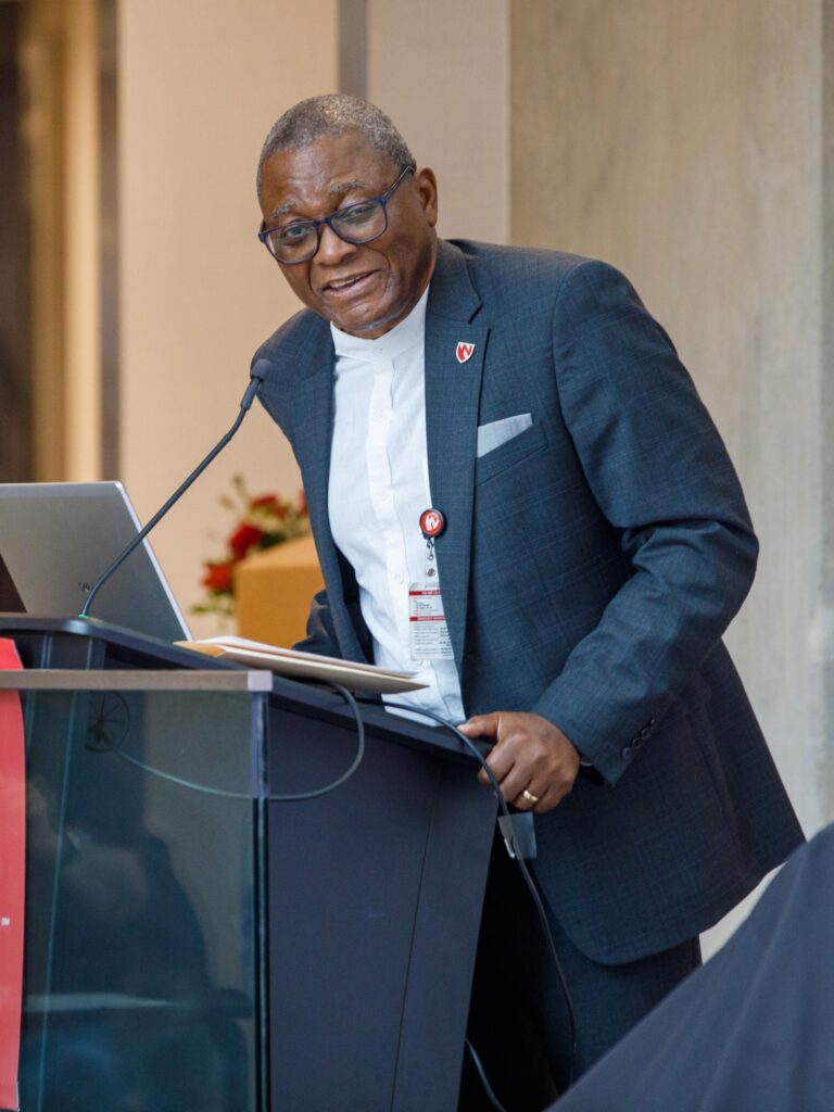 UNMC Chancellor H. Dele Davies, MD, smiles at the podium as he looks to his left during the event to celebrate Kyle Meyer, PhD, and his role as dean of the UNMC College of Public Health.