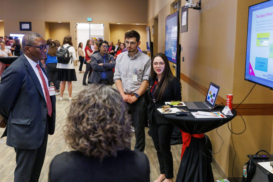 UNMC Chancellor H&period; Dele Davies&comma; MD&comma; watches an E-Learning demonstration at the 2026 showcase event&period;