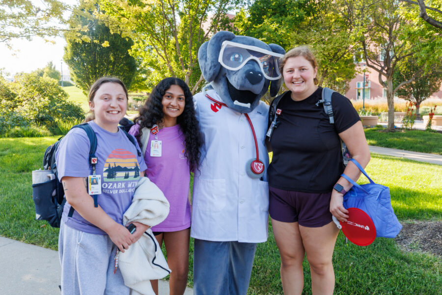 Members of the UNMC community pose with Ellie the Lab on Thursday at the &num;WeAreUNMC BBQ&period;