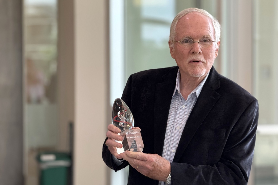 Peter Iwen&comma; PhD&comma; accepts a service award at his retirement reception in July&period;