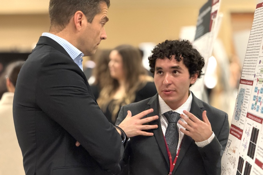 Sam Acosta Castellanos&comma; right&comma; explains his summer research project at the SURP poster session on Aug&period; 6&period;
