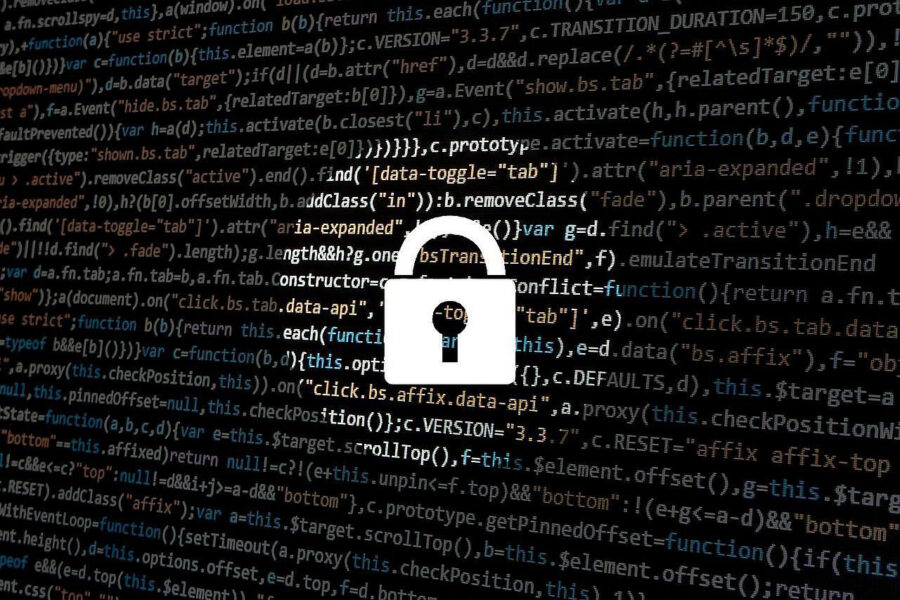 A white padlock is centered in the image in the middle of a round spotlight on top of a field of computer language, which is more visible in the spotlight surrounding the lock