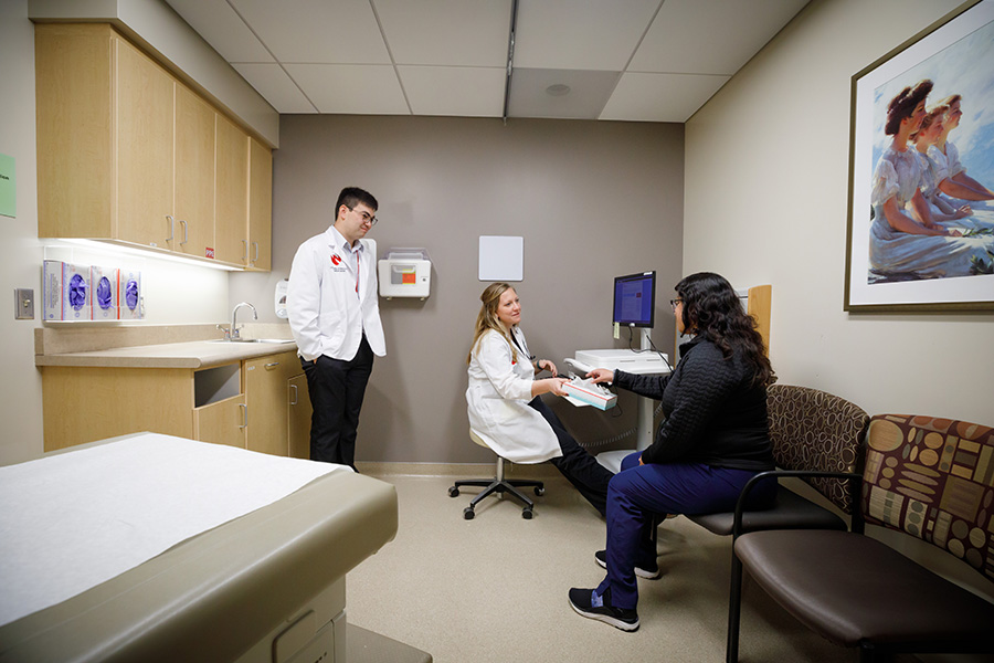 Simulated patient in the Olson Center with student and doctor