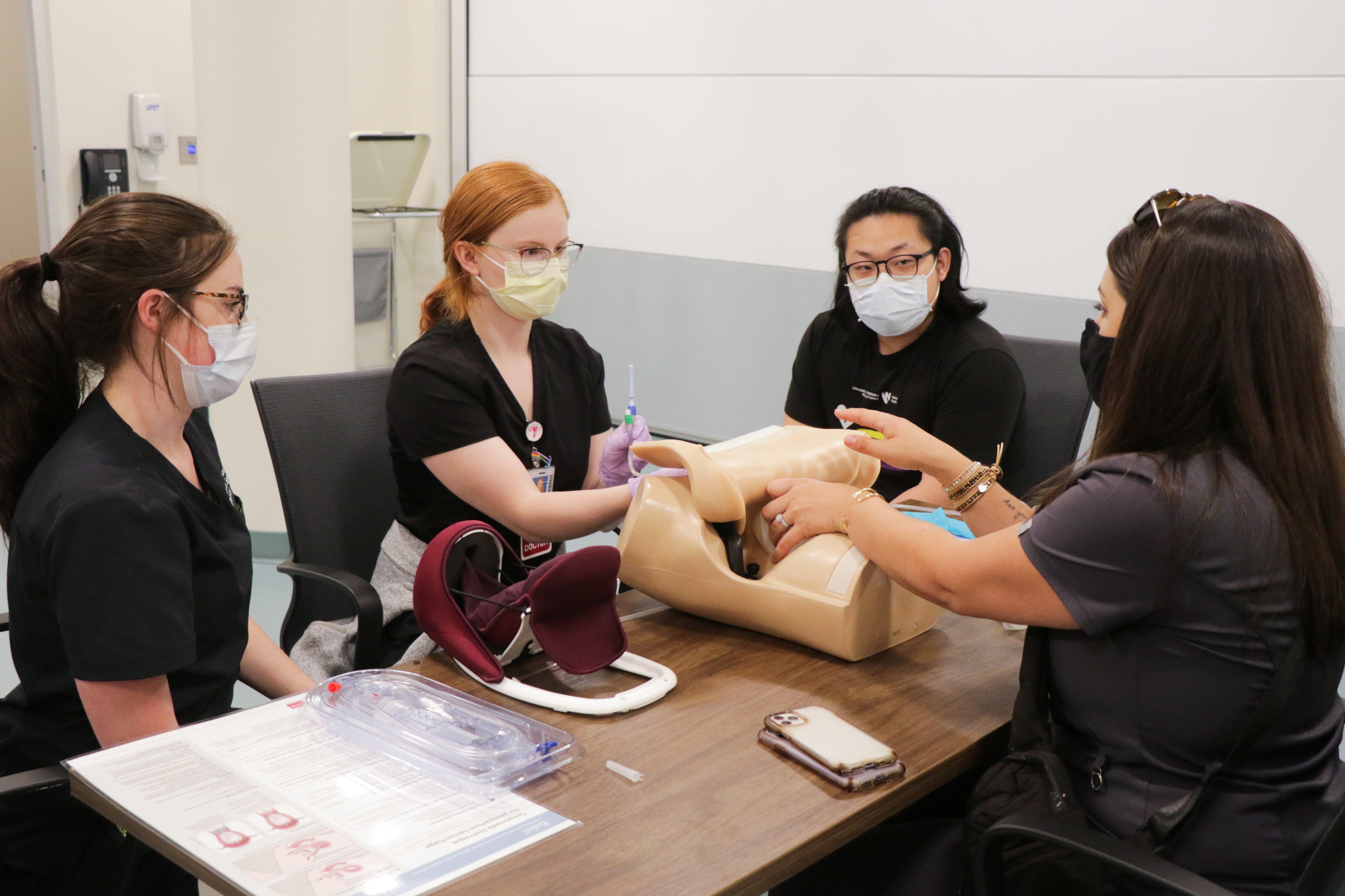 Residents and M4s participate in advanced simulation with female task trainers