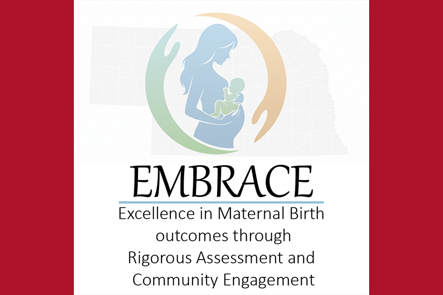 EMBRACE logo - silhouette of female holding a baby and outline of Nebraska map in the back