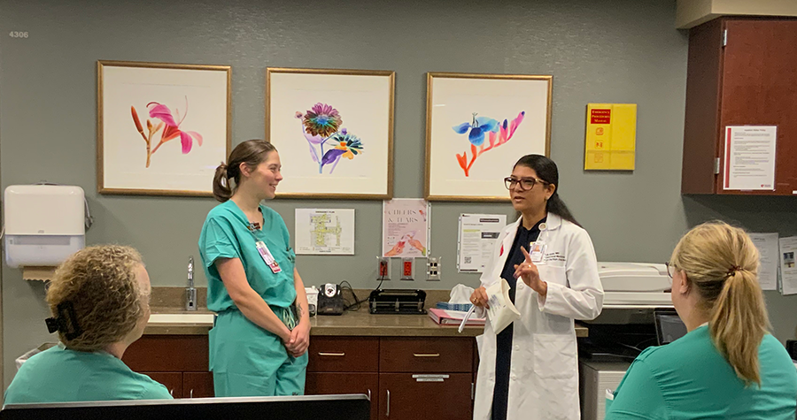 Dr. Sarosh Rana (on right) talking to Nebraska Medicine resident and staff.