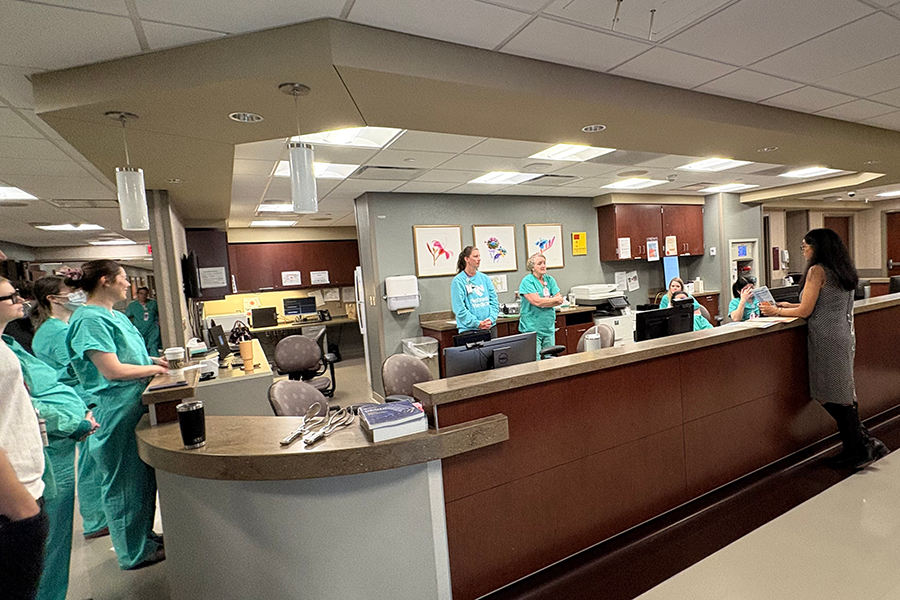 Health care workers and providers at a hospital nursing station