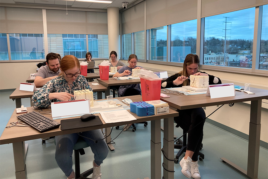 Medical students practicing obstetric laceration repair