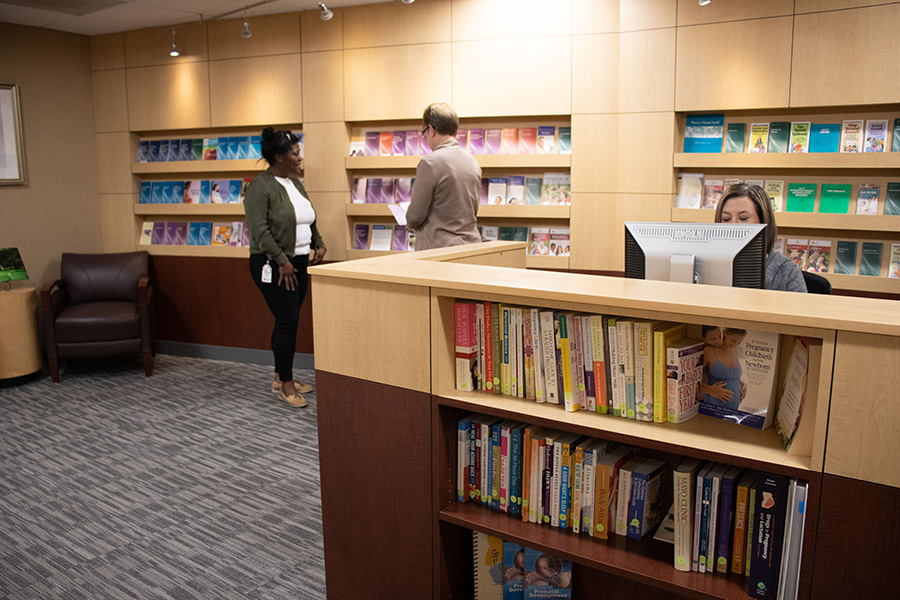 Olson Women's Health Resource Center lobby with pamphlets, staff, and patients