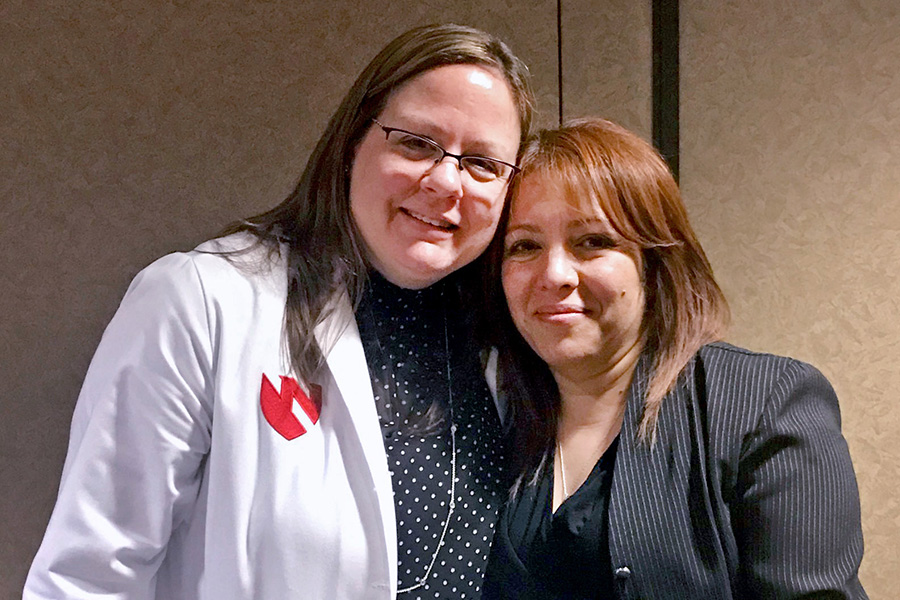 Charity Evans, MD, left, with Raquel Salinas, who shares the story of her son, Roberto Gonzalez, with at risk youths in the Dusk to Dawn program.