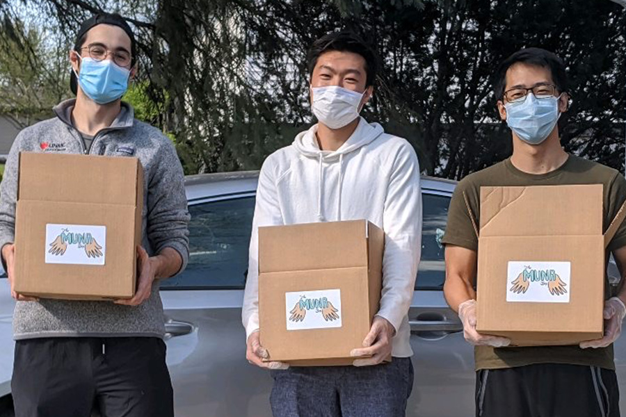 Students hold care boxes they created for members of the community