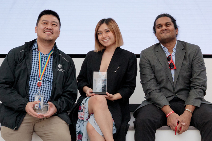 Students pose holding their awards