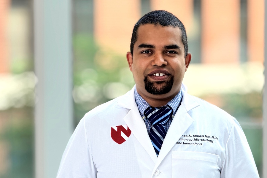 Ahmed Ahmed, man in white lab coat