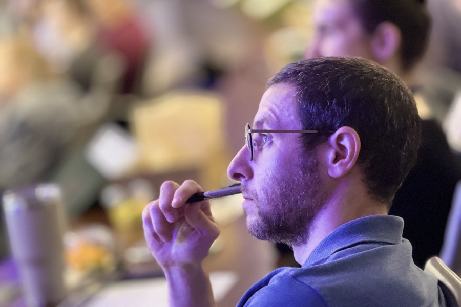 Man looking intently in crowded auditorium