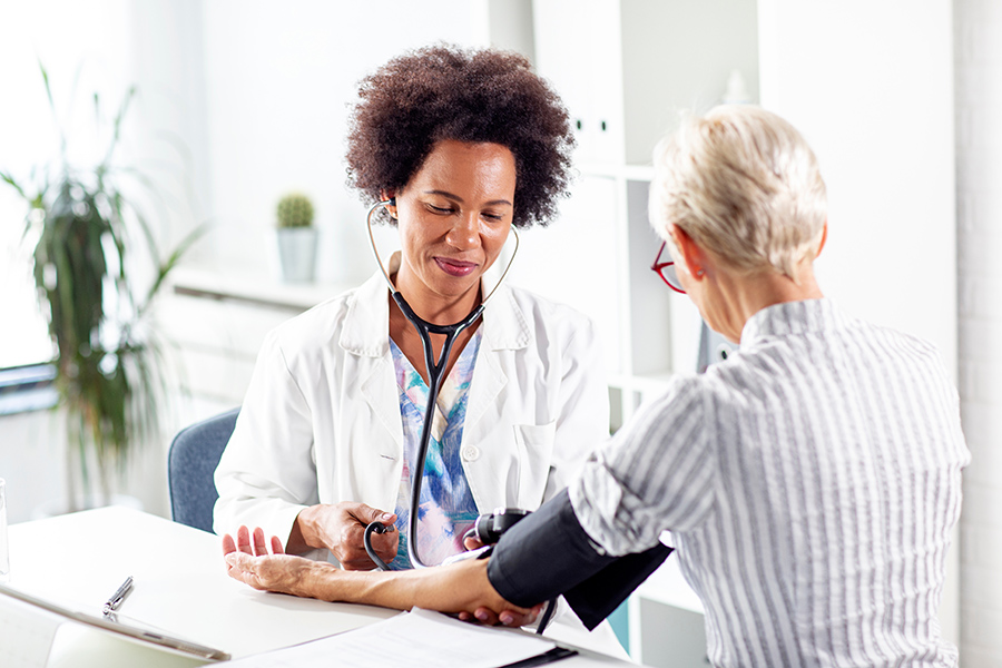 provider taking a patient's blood pressure