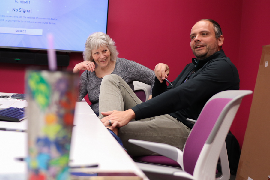 man and woman talking and laughing at table