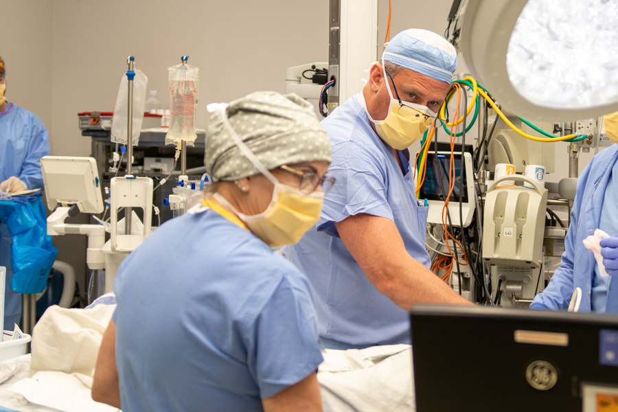 doctor and nurse looking at monitor in operating room