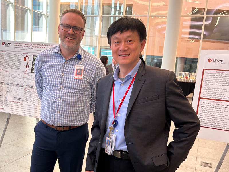 two researchers at scientific poster show