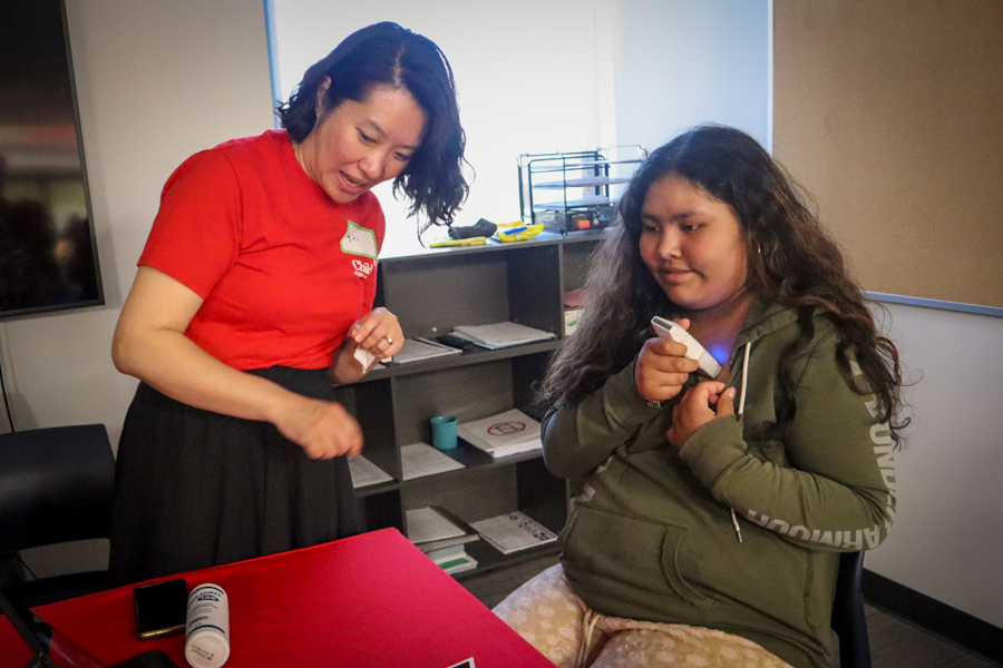 child measuring heart beat with help of female scientist