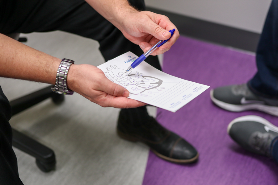 man holds drawing of a heart