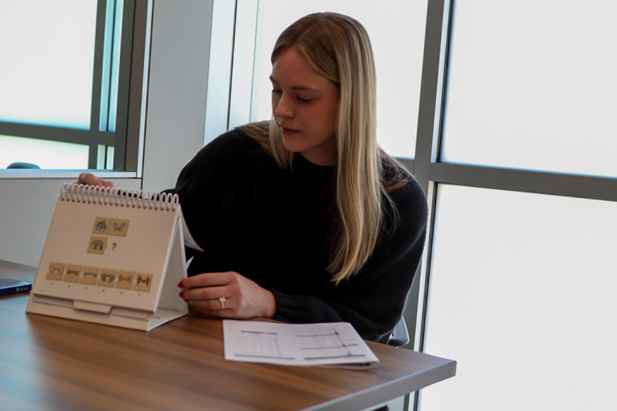 woman sets up developmental pediatrics tools on a table