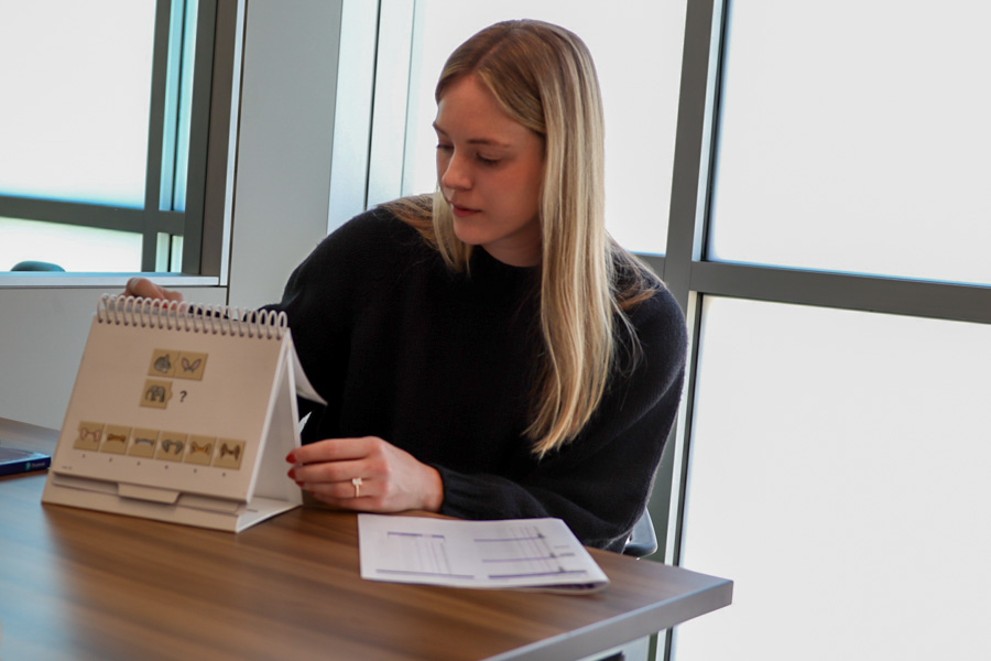 woman sets up developmental pediatrics tools on a table