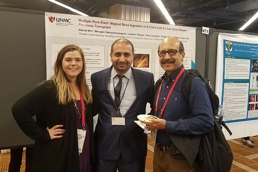 Fellows in front of scientific poster