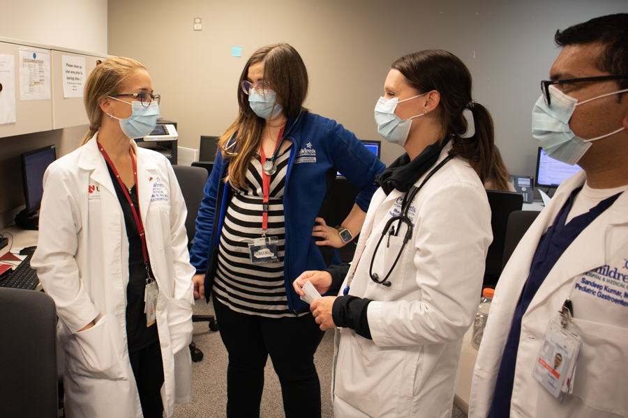 three fellows and doctor talking in a clinic