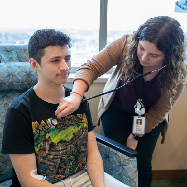 doctor listening to patient's heart with stethoscope