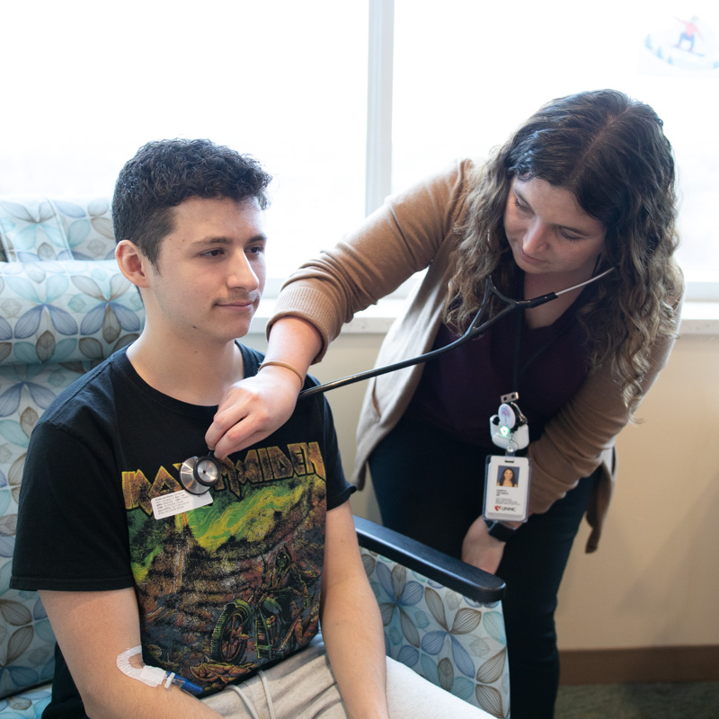 doctor listening to patient's heart with stethoscope