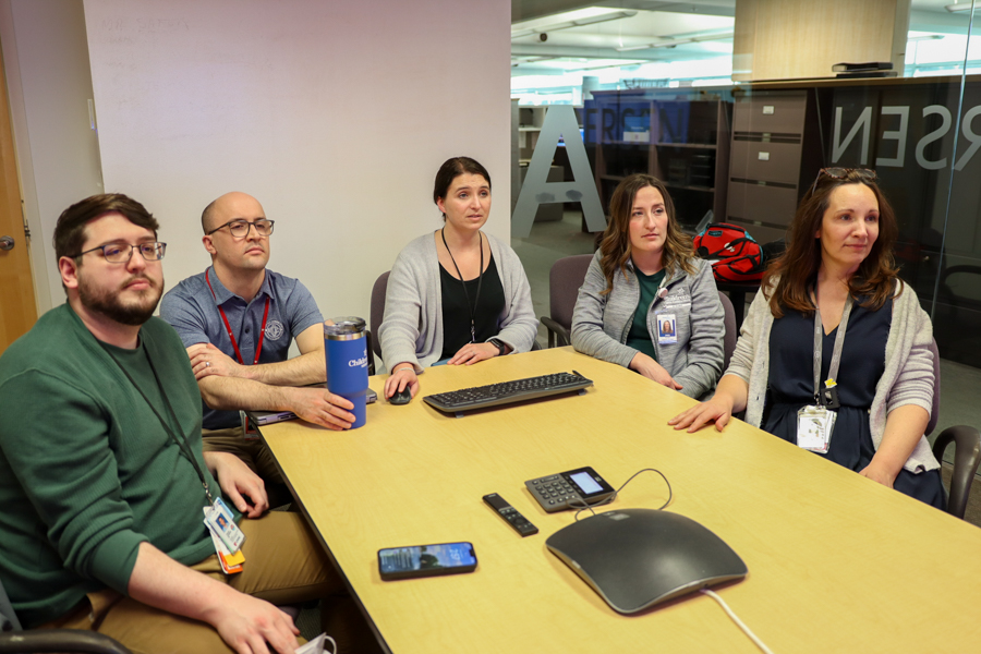 genetics doctors and students sitting around conference table