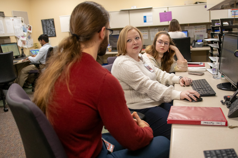 Hem/Onc fellows discuss case sitting at desk