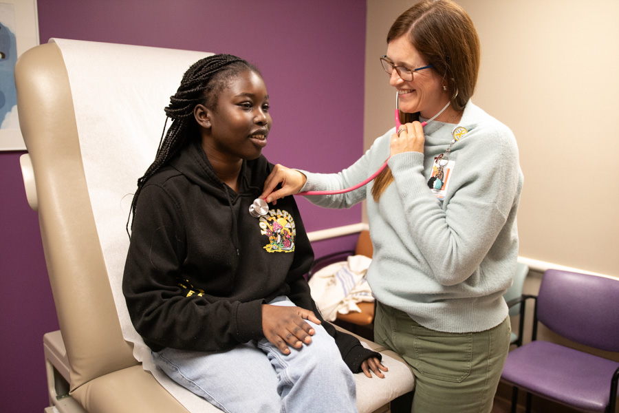 doctor examines patient with stethoscope