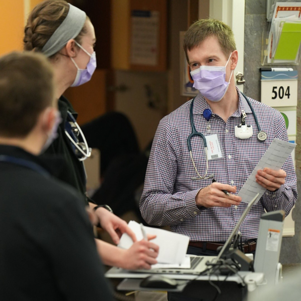 doctor talking to staff