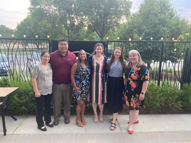 fellows and faculty standing up for a photo