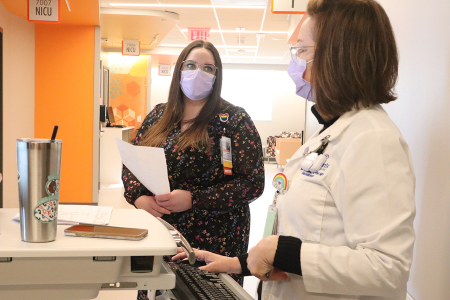 fellow listening to provider on floor of the NICU