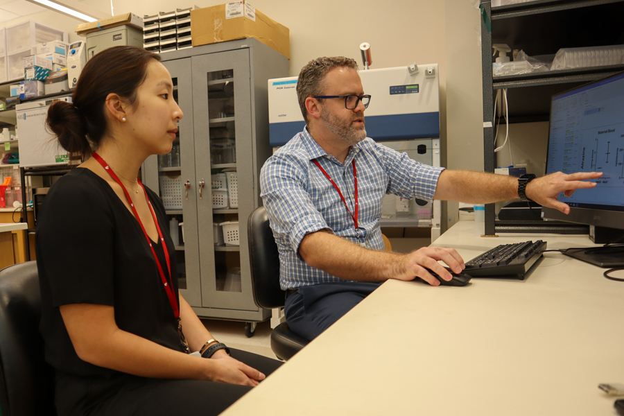 woman and man in lab looking at computer