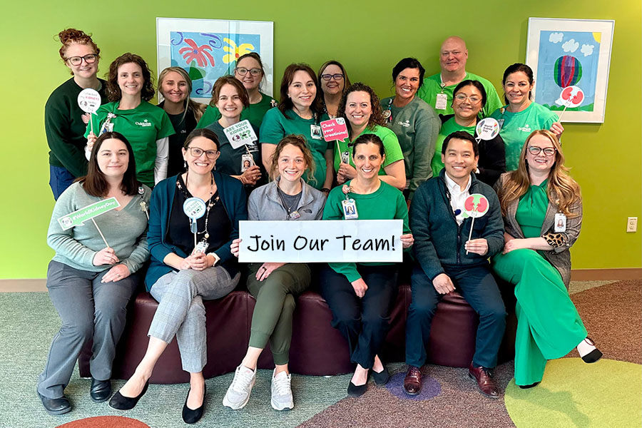 nephrology team in matching shirts holds sign that says join our team