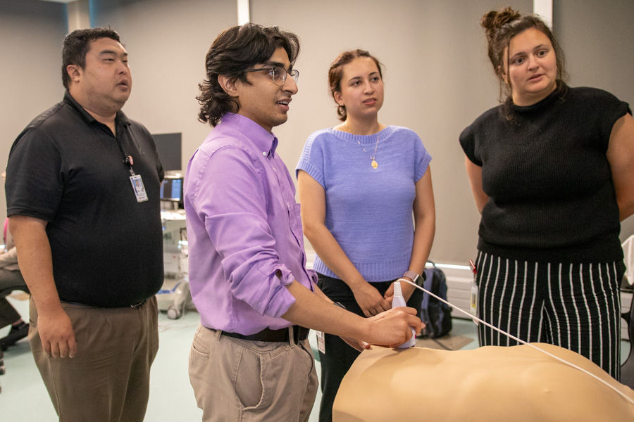 two med students working on procedure in class