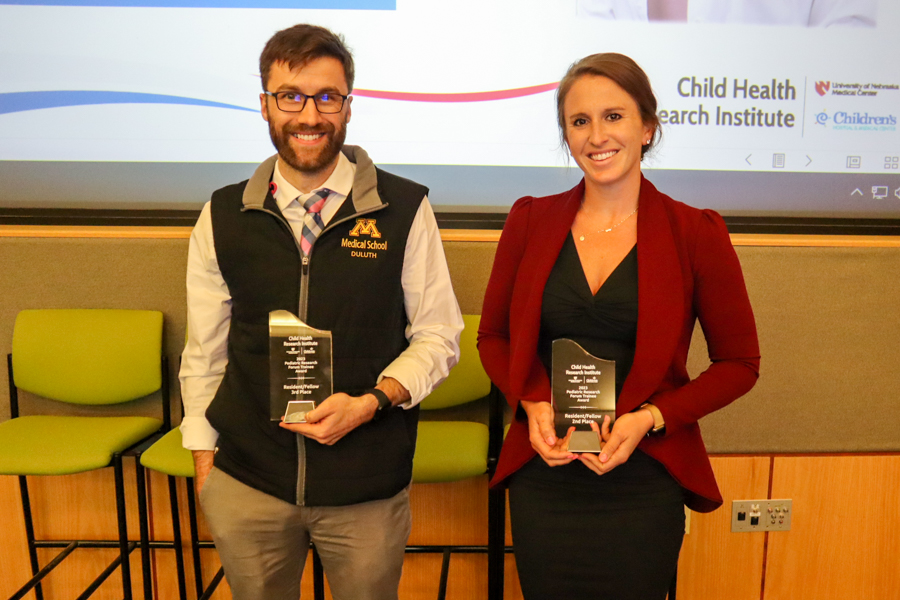 fellows posing with research awards