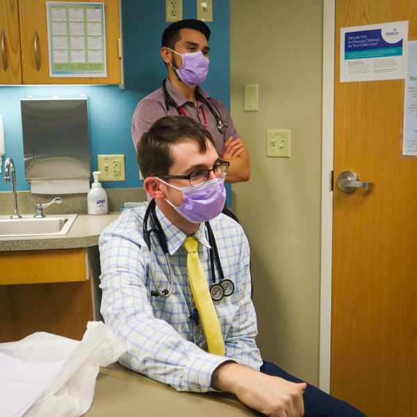 doctor with resident standing behind him