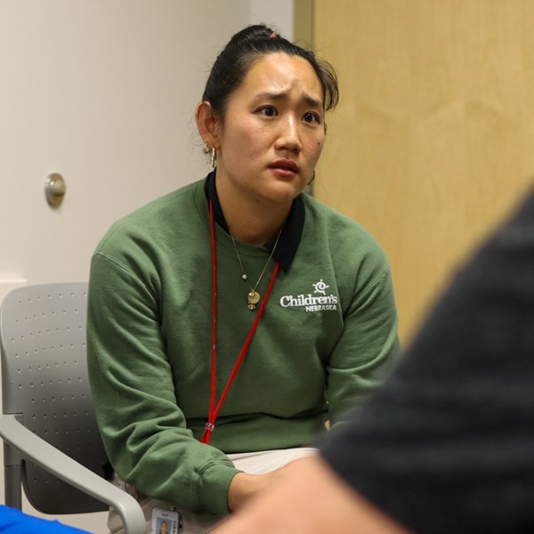 developmental doctor leaning in listening to parents