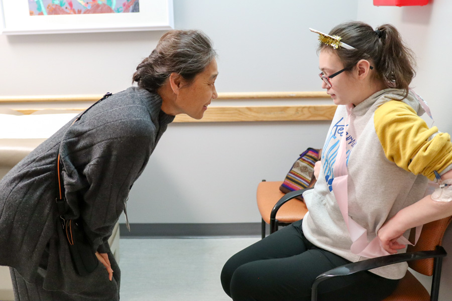 doctor looks at patient sitting across from her in chair