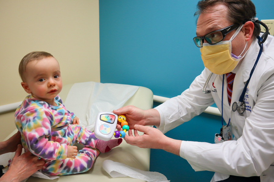 Doctor presenting child with toy 