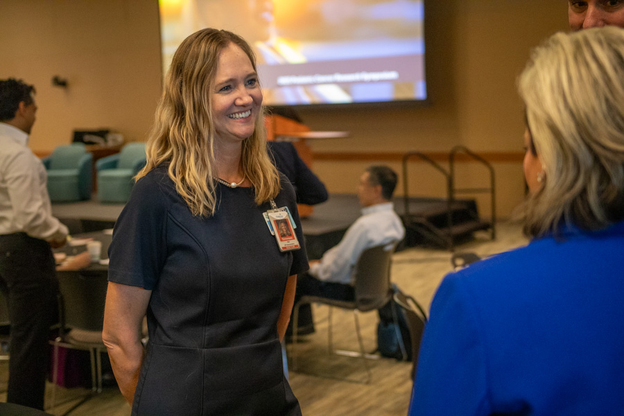 a woman smiling at another woman in conversation