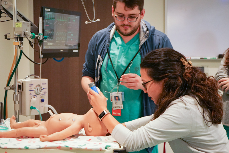 Residents training on baby mannequin