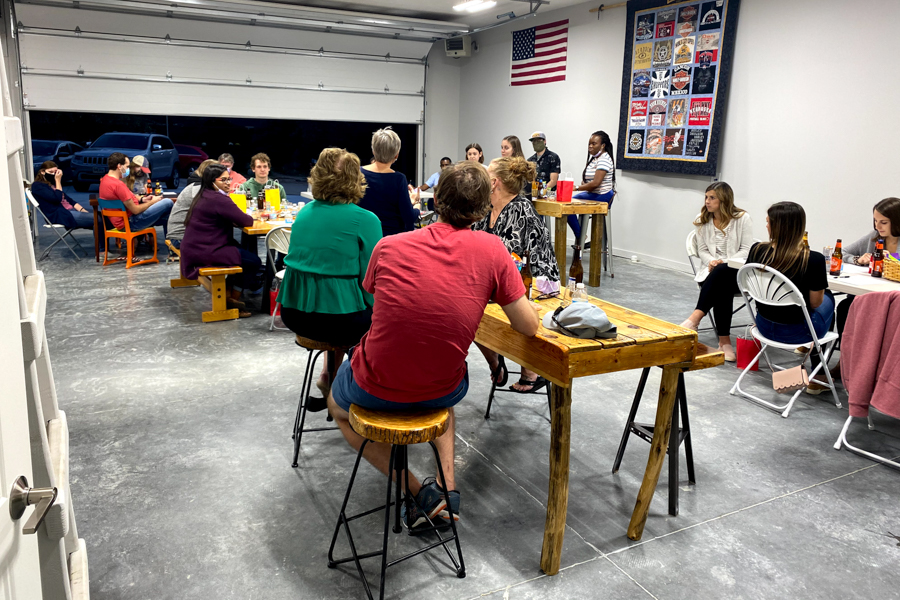 residents sitting in a garage listening to wellness speaker