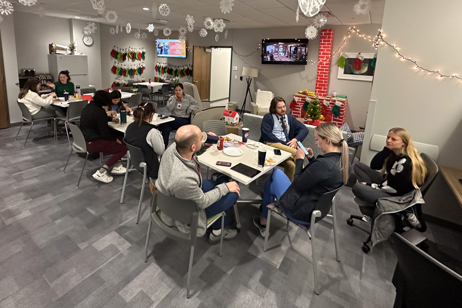 residents talking in a lounge at multiple tables